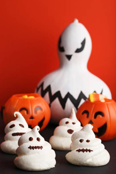 istock Halloween meringue with pumpkins on orange background 1022234464