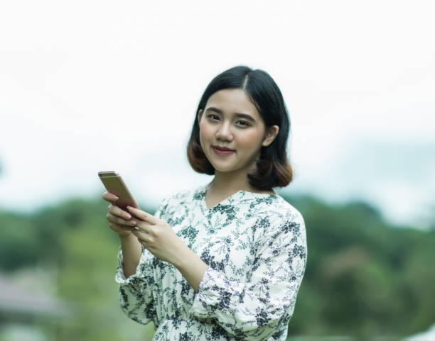 istock Young asian woman holding cellphone 1022234598
