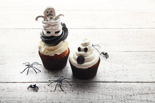 istock Halloween cupcakes with skeletons on white wooden table 1022237152