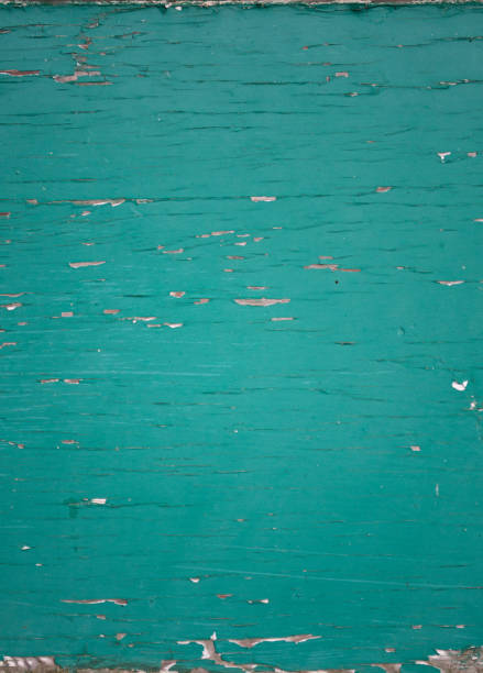 Grungy closeup of peeling flaking green paint on plywood wallpaper Grungy closeup of peeling flaking green paint on plywood wallpaper background green painted wood texture stock pictures, royalty-free photos & images
