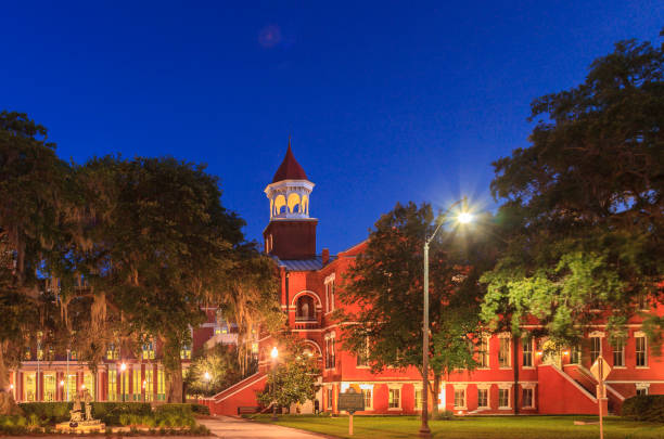 Osceola County Florida Courthouse Square Night falls over the Osceola County Florida Courthouse Square where the oldest, continuously used courthouse in that state - with its lighted cupola - can be seen in the center of the image. kissimmee stock pictures, royalty-free photos & images