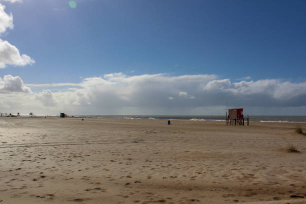 istock winter day, blue sky, pompous white clouds, wide desert beach. 1022246136