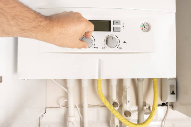 istock Man turning on a Combi Gas Boiler 1022246658