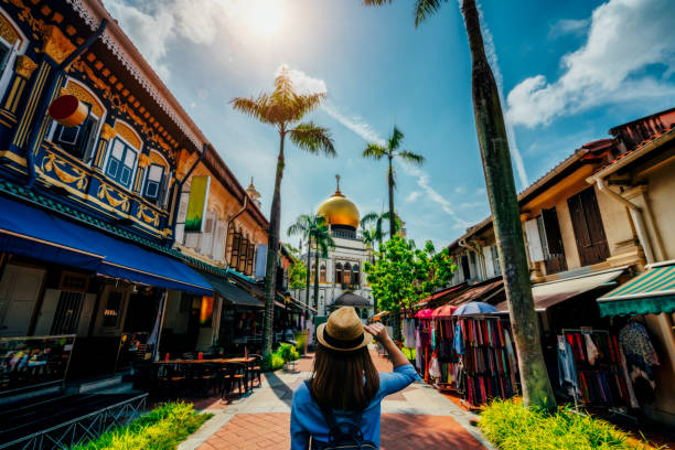Young woman traveler traveling into The Masjid Sultan mosque located in Kampong Glam in Singapore city. Young woman traveler traveling into The Masjid Sultan mosque located in Kampong Glam in Singapore city. singapore city stock pictures, royalty-free photos & images