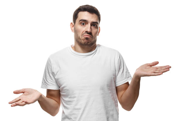 istock I don't know. Young man isolated on white background, showing helpless gesture with arm and hands, mouth curved as if he does not know what to do 1022250190