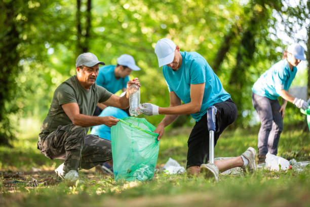 istock Young man with prosthetic leg cleaning the park 1022255244