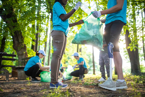 istock Young unrecognizable man with prosthetic leg cleaning the park 1022255582