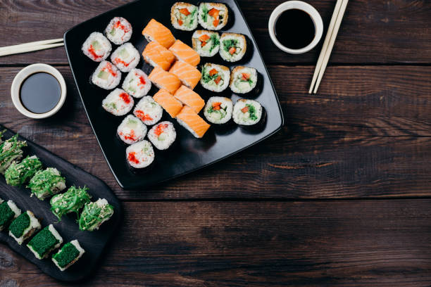 istock Japanese gourmet sushi rolls served on black trays 1022256108