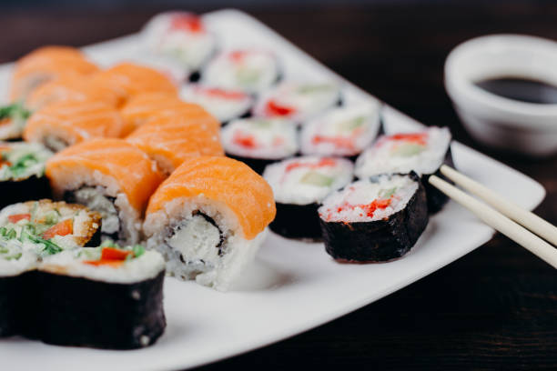 istock sushi set on white plate with sauce and chopsticks 1022256112