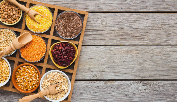 istock Cereals and legumes assortment on wooden table 1022262718