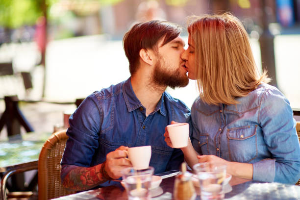 Couple Kissing In Cafe