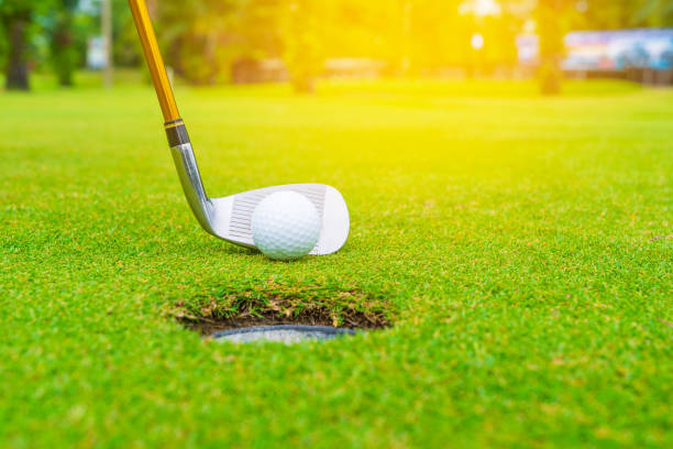 istock Golf course green and golf ball close in the grass field. 1022263860