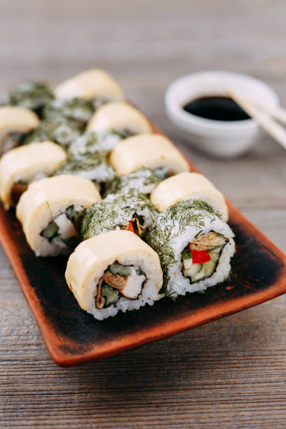 istock sushi rolls set served on original clay plates 1022270856