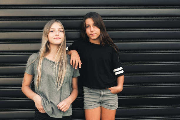 Two teenage girls having fun in the urban part of the city.