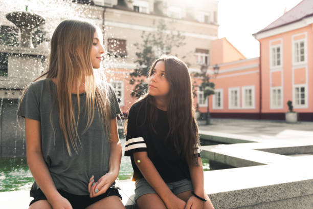 Two teenage girls having fun in the urban part of the city.
