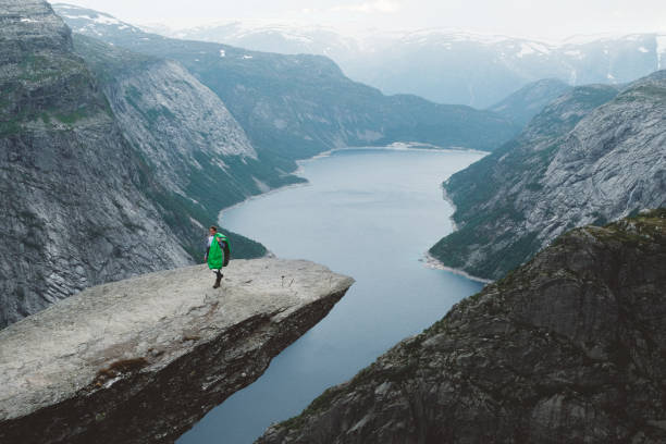 istock Happy woman with sleeping bag on Trolltunga 1022271662