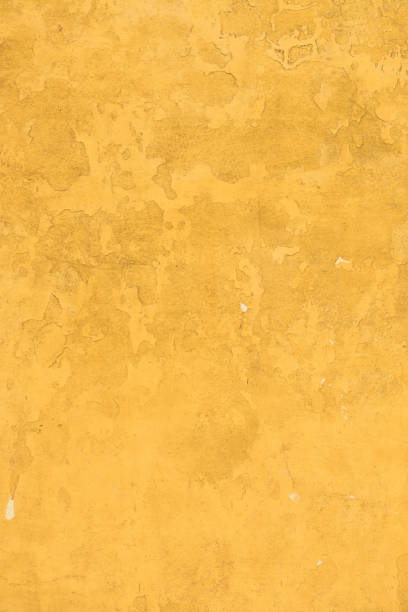 istock Wall covered in yellow painted weathered stucco 1022277362