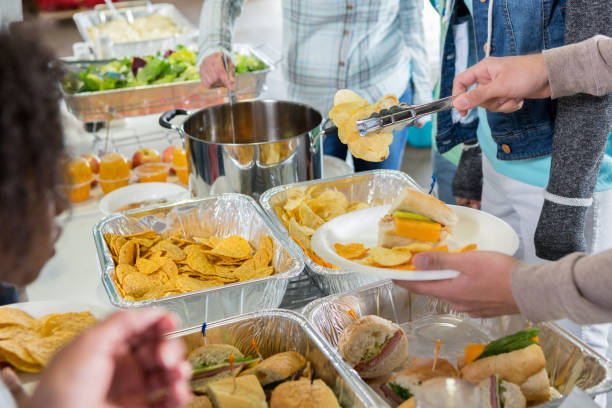 istock Volunteers serve the homeless in soup kitchen 1022277604
