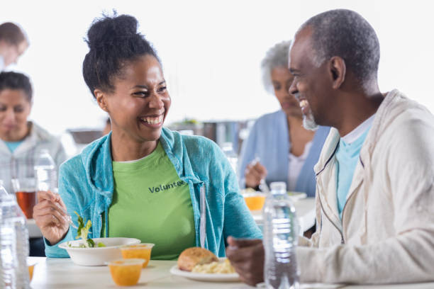istock Mid adult woman eats lunch in soup kitchen 1022277652