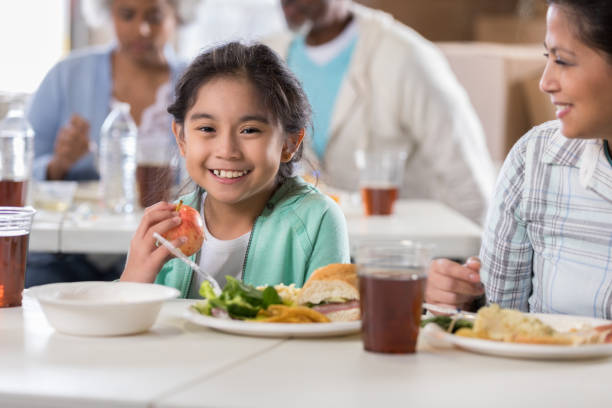 istock Young girl eating healthy meal in soup kitchen 1022277708