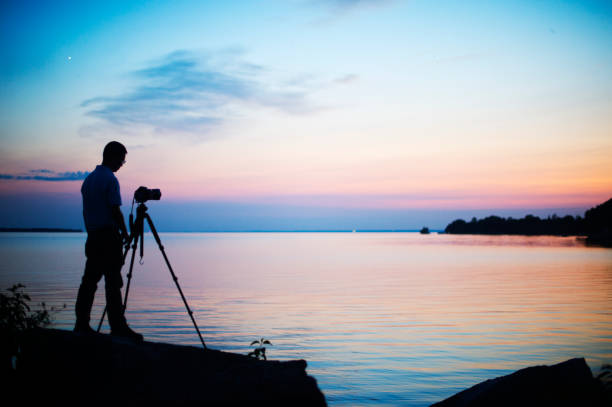 istock Photographer silhouetted against sunset 1022291146