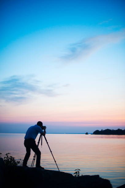 istock Photographer silhouetted against sunset 1022293362