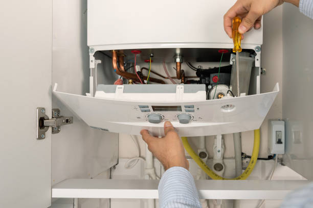 Technician repairing combi Gas Boiler Technician repairing combi Gas Boiler radiator heater photos stock pictures, royalty-free photos & images