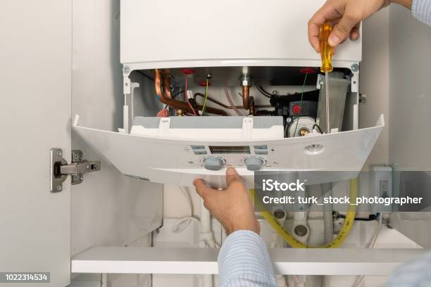 Technician Repairing Combi Gas Boiler Stock Photo - Download Image Now - Boiler, Natural Gas, Radiator - Heater