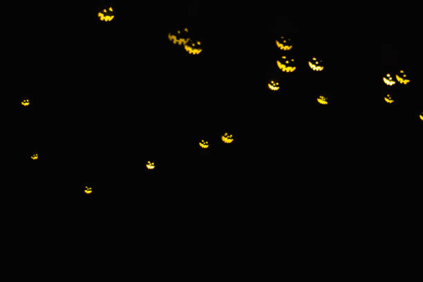 istock Magic background with colorful bokeh in shape of flying ghost  on black backdrop. Card for halloween product 1022317614
