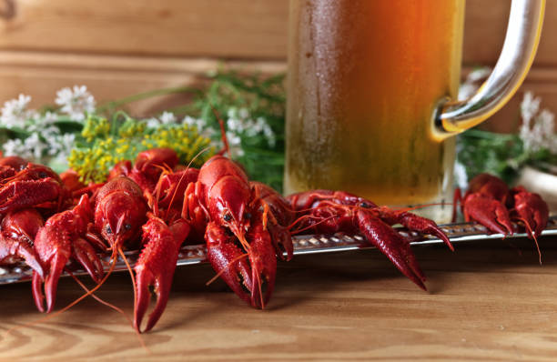 istock Boiled crawfish with dill and mug of beer . 1022319102
