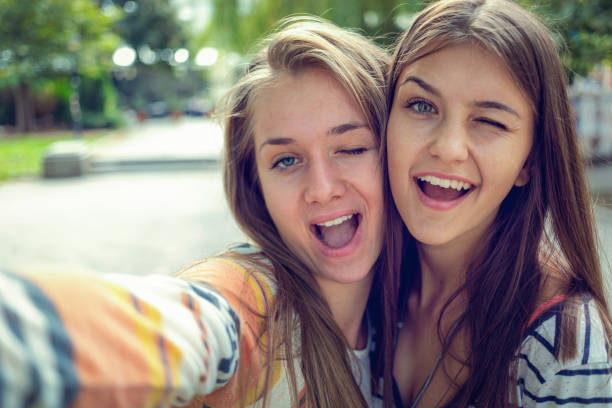 istock Cheerful teenagers grimacing for selfie 1022319366