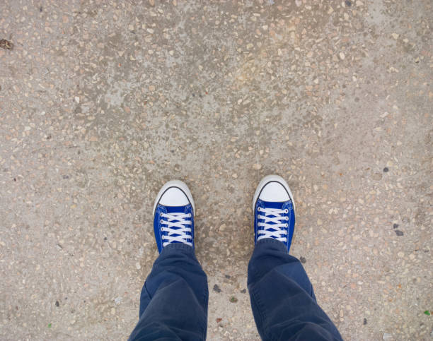 istock Feet on the curb. 1022324128
