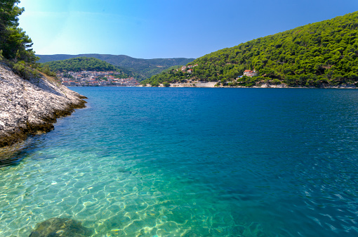 Blue and clear sea in bay near Pucisca on the island of Brac in Dalmatia, Croatia. Sunny summer day. Holidays travel destination.