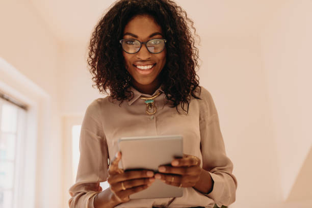 istock Businesswoman standing holding a tablet pc 1022329738