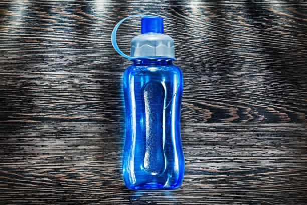 istock Plastic water shaker on vintage wooden board 1022329872