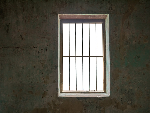 Window with bars against old walls,isolated on white background with clipping path for background images.