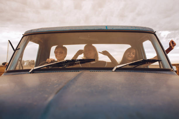 istock female friends having fun on road trip 1022336384