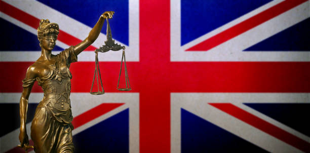 istock Lady Justice before a UK flag 1022344854