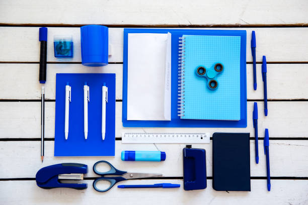 istock stationery pen scissors notebook on a wooden table 1022348102