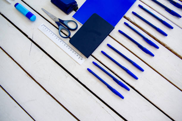 istock stationery pen scissors notebook on a wooden table 1022349026