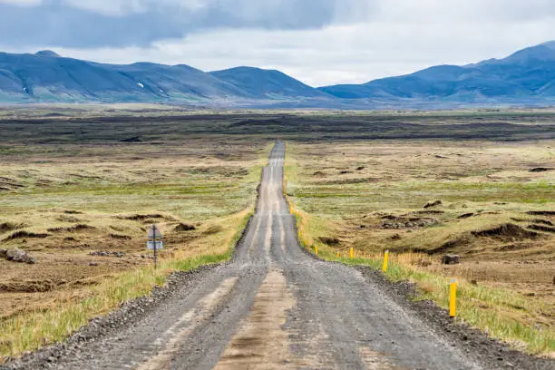 Photo of Dirt road in north east Iceland highlands highway 864 to Dettifoss with barren bare brown landscape, car and moss, grass on rocks, overcast cloudy day, volcanic landscape