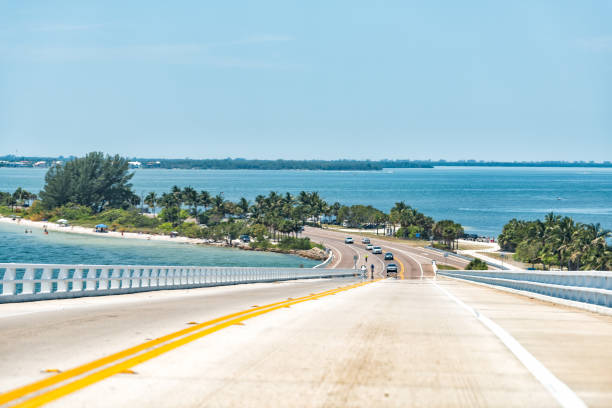 Sanibel Island, USA bay during sunny day, toll bridge highway road causeway, turquoise water, cars Sanibel Island, USA bay during sunny day, toll bridge highway road causeway, turquoise water, cars sanibel island stock pictures, royalty-free photos & images