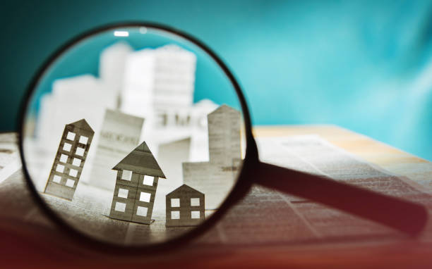 istock Paper house under a magnifying lens 1022372584