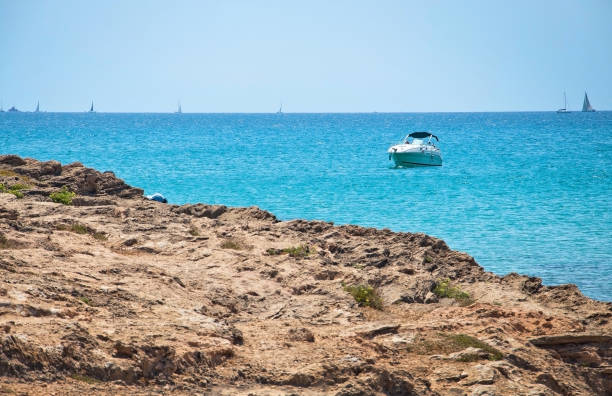 istock Seascape with rocks and boat 1022379896