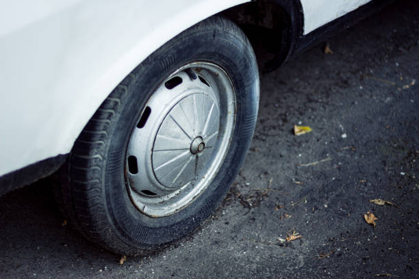 istock Classic European white car shiny wheel on asphalt. 1022380158