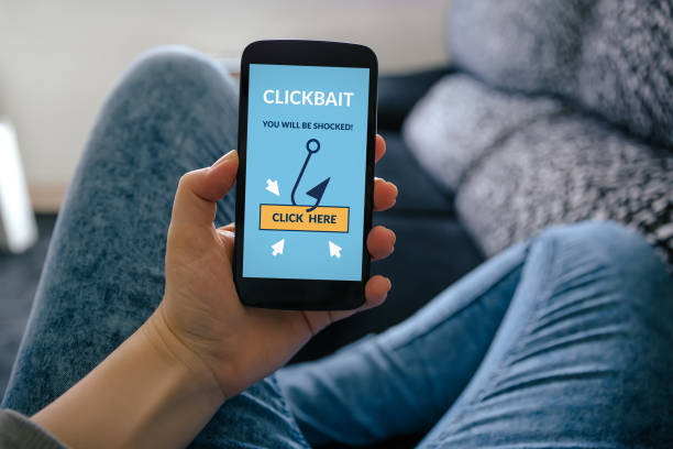 istock Girl holding smart phone with clickbait concept on screen 1022382758