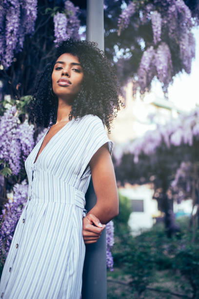 istock Young black woman surrounded by flowers 1022383762