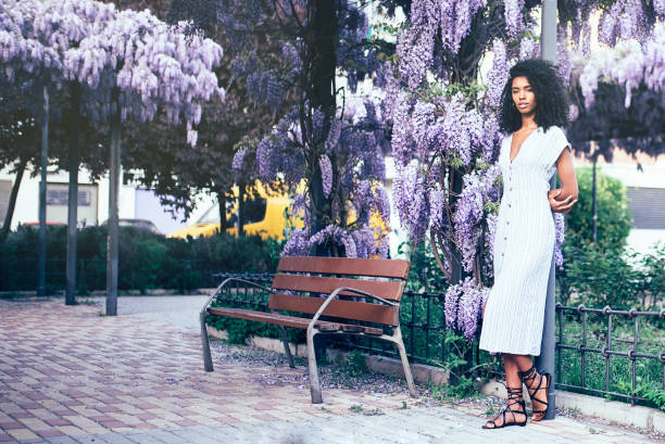 istock Young black woman surrounded by flowers 1022384438
