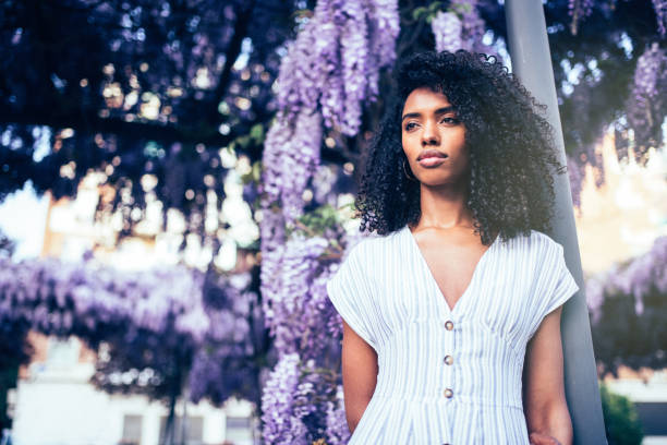 istock Young black woman surrounded by flowers 1022384948
