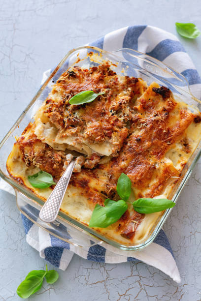 istock Pan with stuffed cannelloni with cream sauce. 1022386712